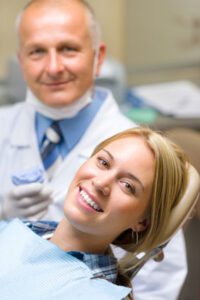 A dentist and a patient looking happy